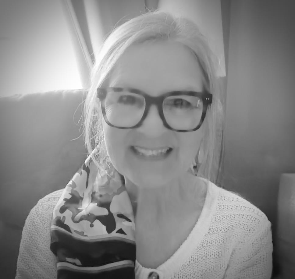 Kathy Fish, smiling, in a black-and-white portrait